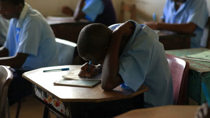 Wall Mural - Students taking a test in a schoolroom in Africa.