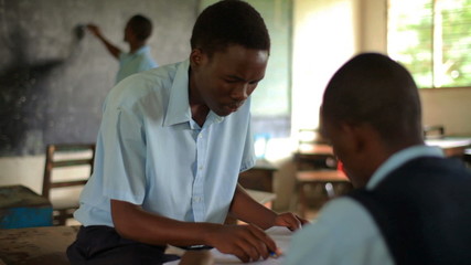Wall Mural - Students taking a test in a Kenyan school.
