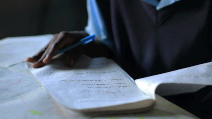 Wall Mural - Some Students taking an exam in school in a village in Kenya.