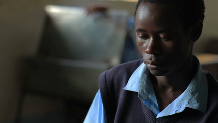 Wall Mural - African Students taking an exam in a class in a village in Kenya.