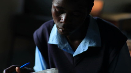 Wall Mural - Students taking an exam in a class in a village in Kenya.
