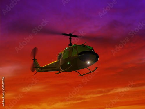 Fotoboard na płycie Latający helikopter uh-1 i czerwony zachód słońca
