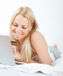 © Andrey Popov - Young beautiful woman shopping using laptop