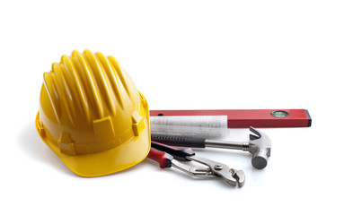 isolated hard hat with tools and blueprint on white