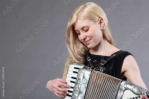 Fotografia, Obraz Beautiful young woman with an accordion.