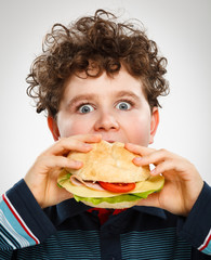 Wall Mural - Boy eating big sandwich