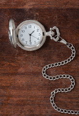 The old clock on a wooden surface