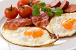 Fried eggs with bacon and tomatoes
