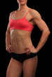 © Nobilior - Female fitness bodybuilder posing against black background
