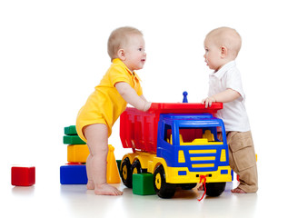 two little children playing with color toys