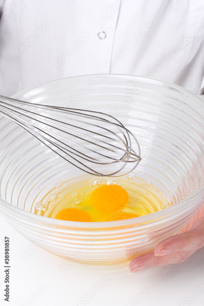 Female hands Mixing eggs in bowl close up