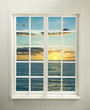 Modern residential window with sunset over sea and clouds