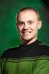 Portrait of the teenager on a green background in green clothes