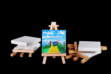 Artists easels stacked on a black background