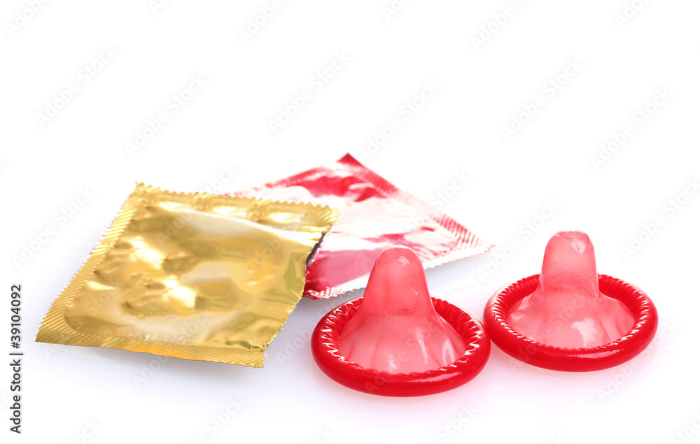 Red condoms with  open packs isolated on white