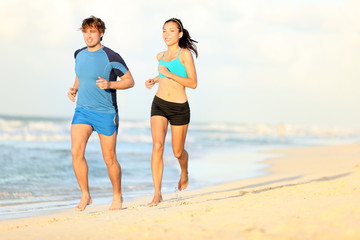 Wall Mural - Couple running on beach