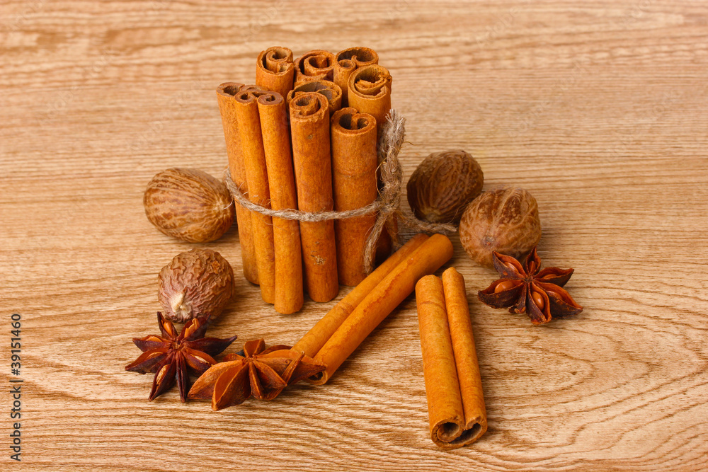 Cinnamon sticks, nutmeg and anise on wooden table