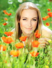 Wall Mural - Beautiful female laying on the flower field