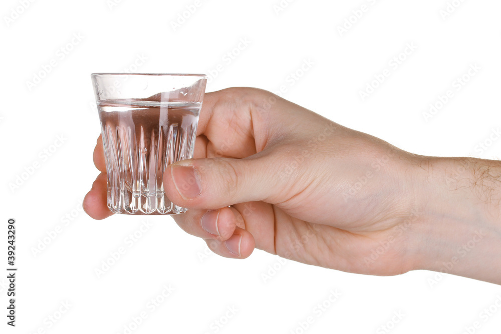 Man's hand holding a glass with vodka isolated on white