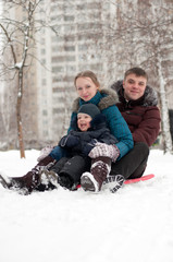  Young family rides to the hills on sleds