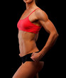 © Nobilior - Muscular female body against black background