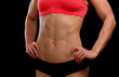 © Nobilior - Muscular female body against black background