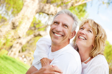 Mature couple smiling and embracing.