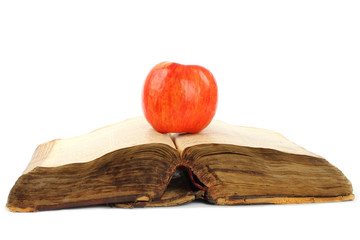 Old book with apple on a white background