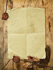 Wall Mural - Old paper with dried rose on wooden background