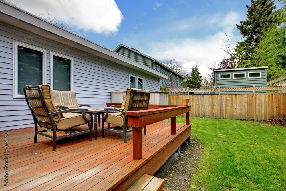 Grey small house with simple deck and outdoor chairs. - obrazy, fototapety, plakaty 