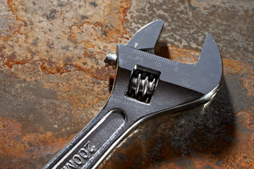 Spanner on the rusty plate