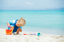 Boy Playing With Beach Toys On Tropical Beach