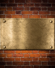 Wall Mural - old golden or bronze plate on brick wall
