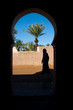 Tuareg man passing through an arched doorway, Mor