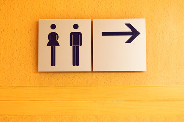 Toilet sign and direction on wood wall