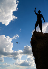 Wall Mural - Man on peak of mountain.