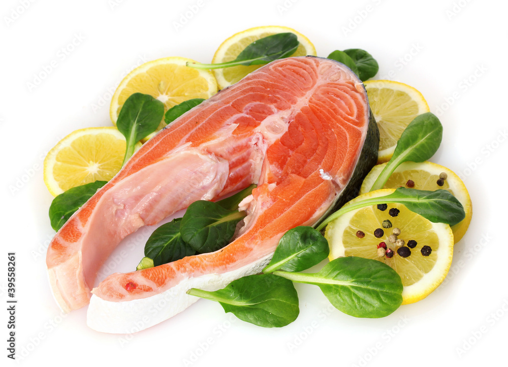 Red fish with lemon, green leaves and pepper isolated on white.