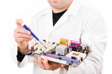 Computer Engineer examining/repairing a electronic circuit, isol