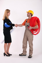 Business Professional Shaking A Tradesman's Hand