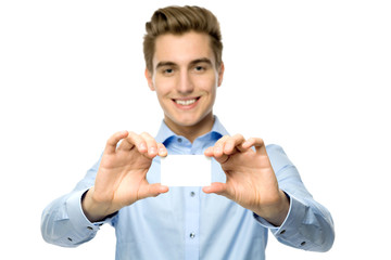 Young man holding blank card