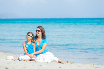 Mother and her little daughter on beach