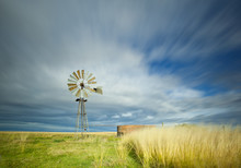 Windmill In Field With Motion In The Clouds