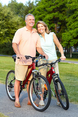 Poster - Senior couple cycling.