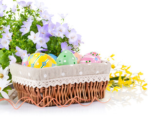 Wall Mural - easter egg in basket with spring flower isolated on white