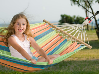 Wall Mural - Summer holiday - lovely girl in colorful hammock