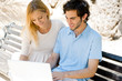 © Milles Studio - Young couple working on laptop and smiling