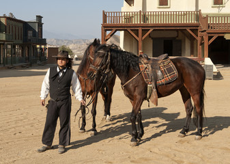 Fototapete - Sheriff holding two horses at Mini Hollywood