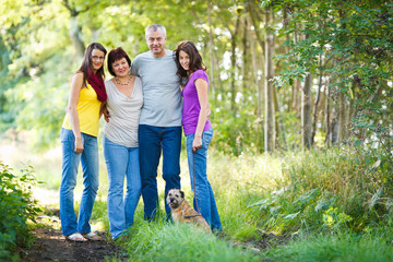 Family portrait - Family of four with a cute dog outdoors