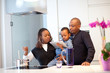 © djma - Young black family in fresh modern kitchen