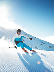 Wall Mural - Skier in mountains, prepared piste and sunny day